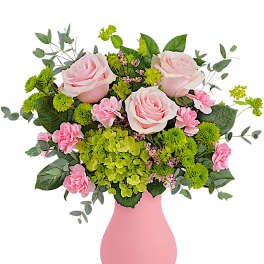 Pink roses and green blooms in a pink vase