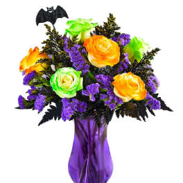 Bouquet of orange and green roses in a purple vase