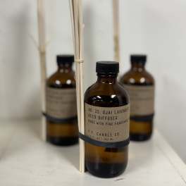 Amber reed diffuser bottles with black caps and reed sticks