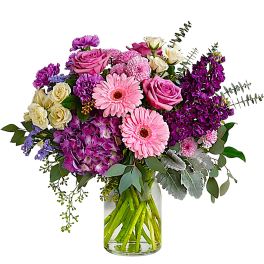Pink and purple mixed bouquet in a clear glass vase