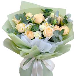 Bouquet of pale peach roses with small white daisies and eucalyptus in green wrap