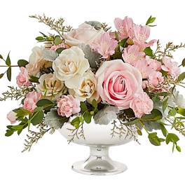 Pink and white floral arrangement in a white pedestal vase