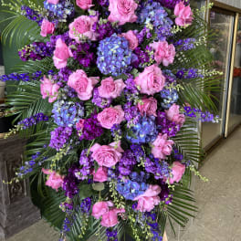 Large standing floral spray with pink roses and purple-blue hydrangeas
