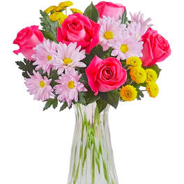 Bouquet of pink roses and daisy-like flowers in a clear glass vase