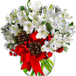 White alstroemeria bouquet in a glass vase with red ribbon and pinecones