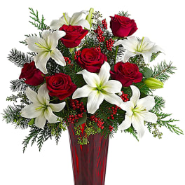 Red roses and white lilies in a tall red vase