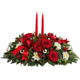 Red rose centerpiece with two lit candles and white flowers