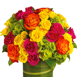 Bright mixed roses in a green glass vase