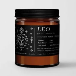 Amber candle jar with a black label and Leo zodiac design