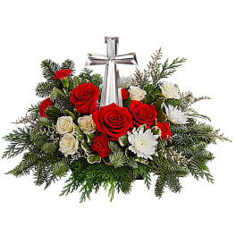 Red and white rose arrangement with a silver cross centerpiece