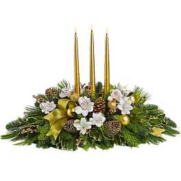 Holiday centerpiece with three gold candles and white flowers