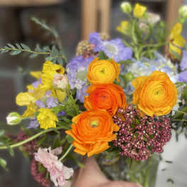 Bouquet of orange, yellow, and lavender flowers