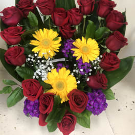 Bouquet of red roses with yellow gerbera daisies and purple filler flowers