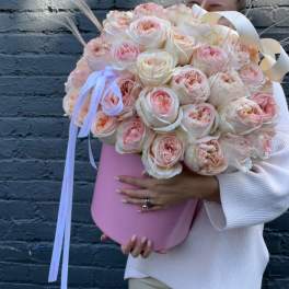 Large bouquet of blush and cream roses in a pink hat box