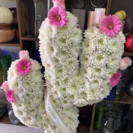 White chrysanthemum standing spray with pink gerbera daisies