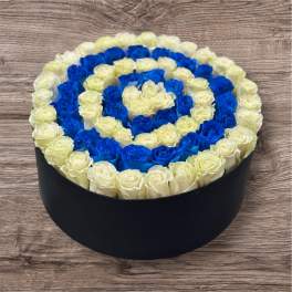Round box of blue and cream roses arranged in a spiral pattern