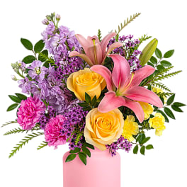 Pink and yellow floral arrangement in a pink vase