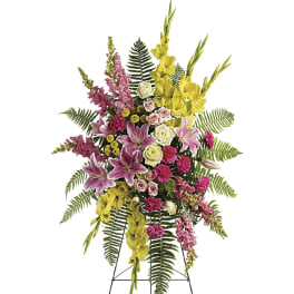 Standing floral spray with pink, yellow, and white flowers on an easel