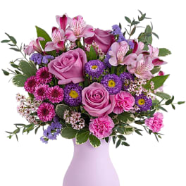 Pink and purple mixed bouquet in a lavender vase