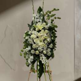 Tall white floral standing arrangement on an easel