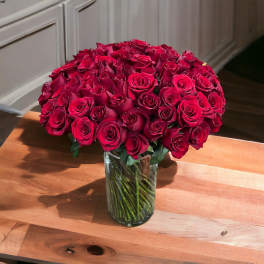Large bouquet of red roses in a clear glass vase