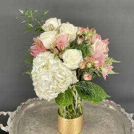 Pink and white bouquet in a gold vase