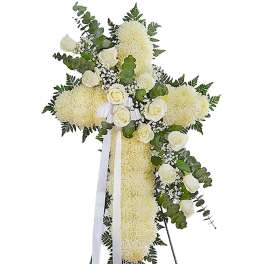 White floral standing cross with roses and ribbon