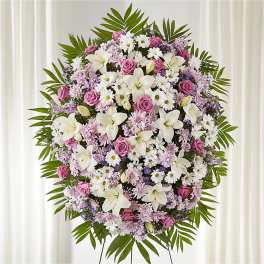 Large standing floral spray with pink, white, and lavender blooms