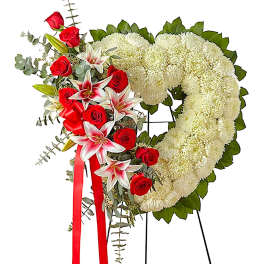 Heart-shaped funeral wreath with white chrysanthemums and red roses