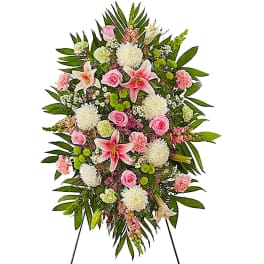 Standing floral spray with pink and white flowers on an easel