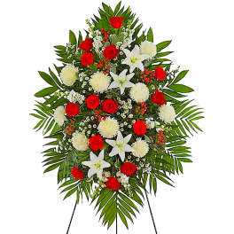 Standing floral spray with red roses, white lilies, and white pompons