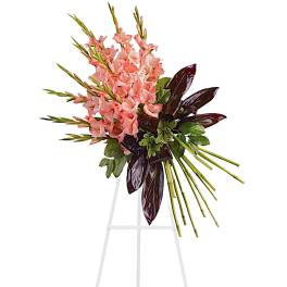 Pink gladiolus arrangement on a white stand