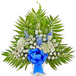 White and blue floral standing spray with a blue ribbon