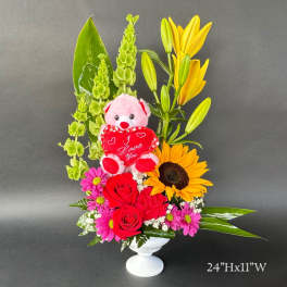 Mixed bouquet in a white vase with a teddy bear and heart