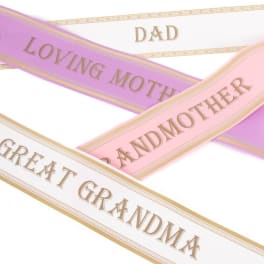 Decorative satin ribbons printed with family titles in pastel colors