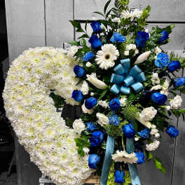 Standing sympathy easel with a white chrysanthemum heart and blue and white floral spray.