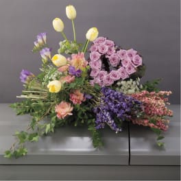 Lavender rose heart arrangement with yellow tulips and mixed flowers