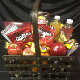 Gift basket with chips, apples, oranges, and bottled drinks