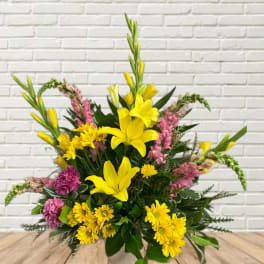 Yellow lilies and pink flowers in a mixed bouquet