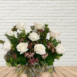 White rose bouquet with pink filler flowers and greenery