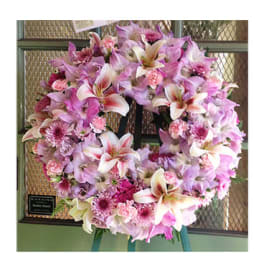 Pink and white floral wreath on a stand
