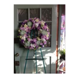 Purple and pink floral wreath on a standing easel