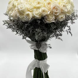Bouquet of white roses with dark filler and white ribbon