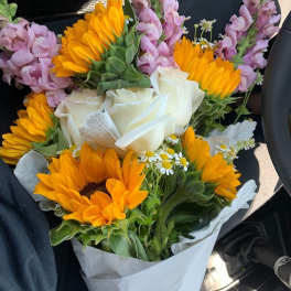 Bouquet of sunflowers, white roses, and pink snapdragons