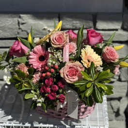Pink rose and gerbera daisy bouquet in a pink basket