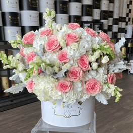 Large pink and white rose arrangement in a white hat box