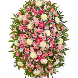 Large standing spray of pink and white flowers with green foliage