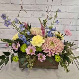 Mixed pastel flower arrangement in a wooden box