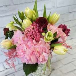 Pink and yellow mixed bouquet in a clear glass vase