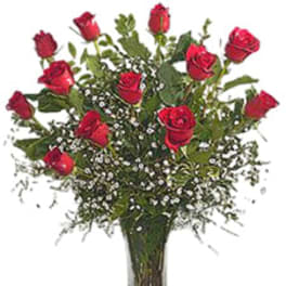 Red roses arranged in a clear glass vase